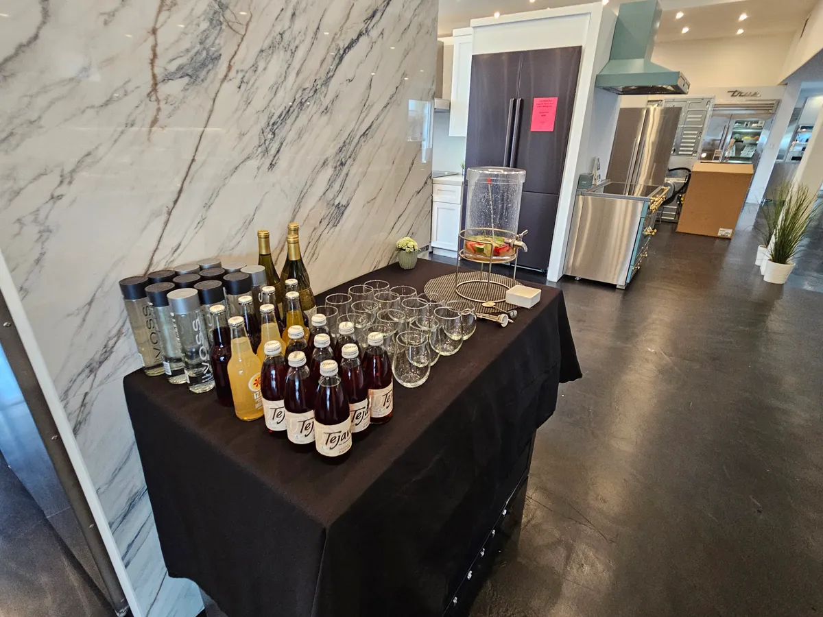 Beverage station with assorted drinks and glasses set up for a sushi-making workshop in San Francisco.