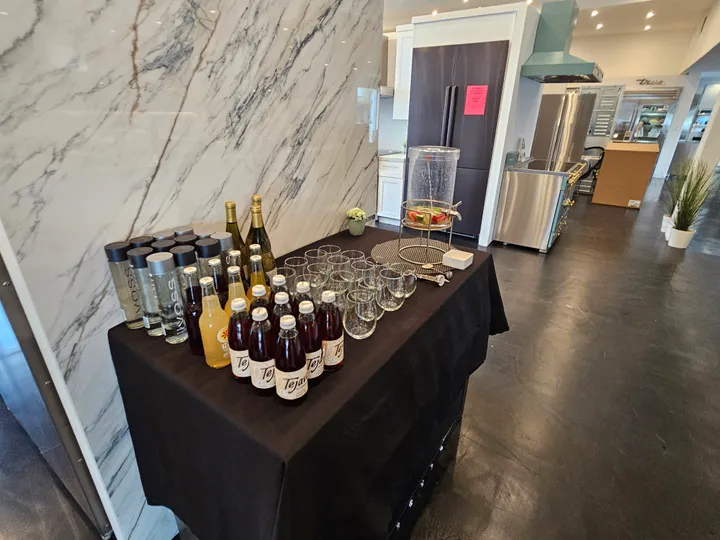 Beverage station with assorted drinks and glasses set up for a sushi-making workshop in San Francisco.