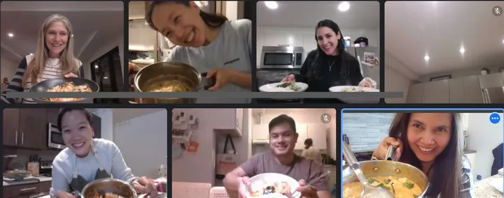 Participants smiling and holding dishes from a virtual Thai Pad-See-Ew cooking class in San Diego.
