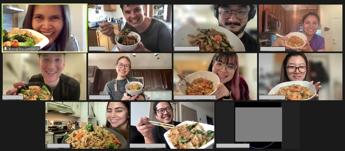 Participants proudly display their cooked Pad-See-Ew dishes during a virtual team building class in San Diego.