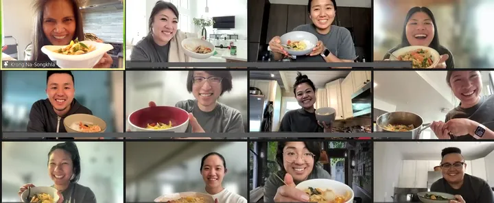 Participants in a virtual Thai Red Curry cooking class in San Diego, showing their completed dishes and smiling.