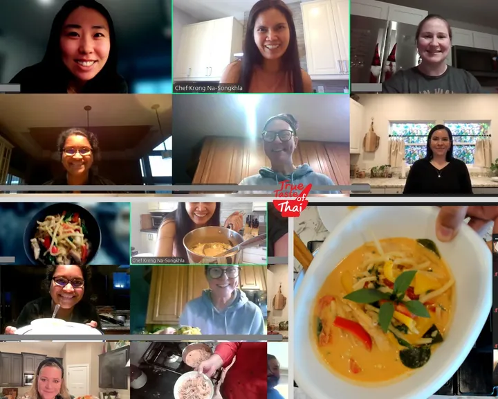 Participants smiling in a virtual Thai Red Curry cooking class, showcasing finished dishes and chef's guidance.
