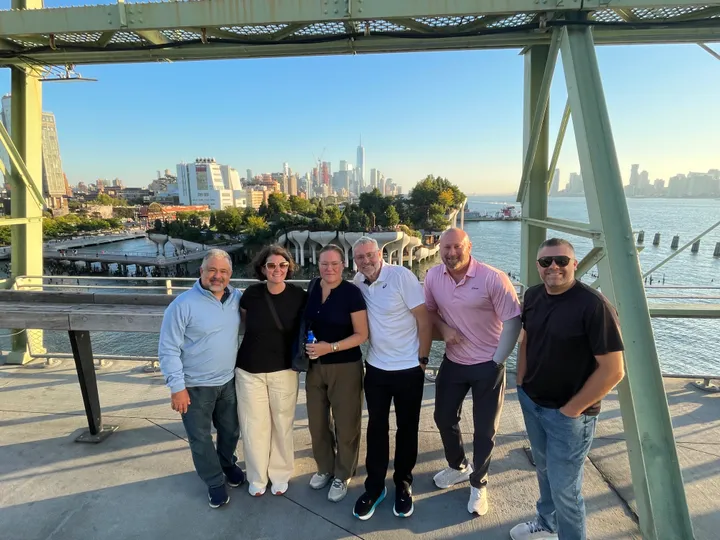 Group of six people enjoying a scenic view in New York City during a VIP Seated Food Tour Experience.